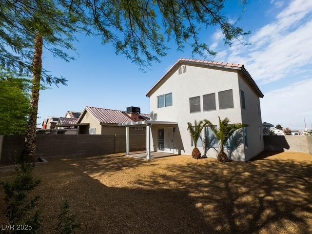 3686 Lincoln Rd, Las Vegas, NV 89115 - back of house with stucco siding, fence, and a patio