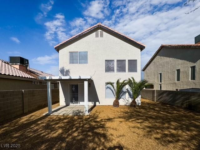 3686 Lincoln Rd, Las Vegas, NV 89115 - back of property with central AC, a patio area, a fenced backyard, and stucco siding