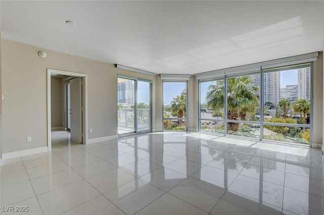 222 Karen Ave Unit 302, Las Vegas, NV 89109 - unfurnished room featuring baseboards, light tile patterned flooring, and floor to ceiling windows