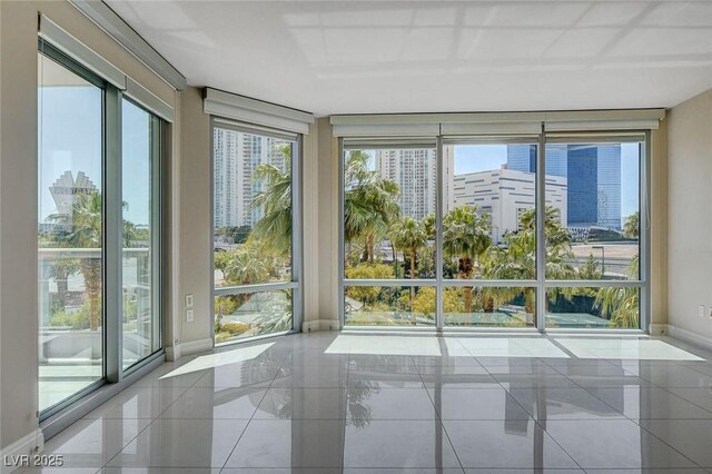 222 Karen Ave Unit 302, Las Vegas, NV 89109 - unfurnished sunroom with a view of city, a wealth of natural light, and baseboards
