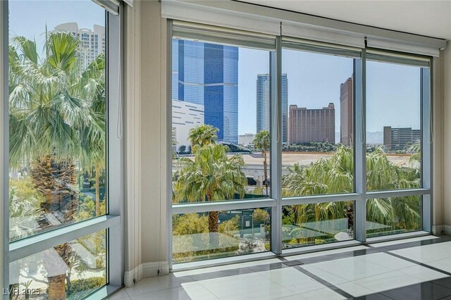 222 Karen Ave Unit 302, Las Vegas, NV 89109 - doorway featuring a view of city, tile patterned flooring, and a healthy amount of sunlight