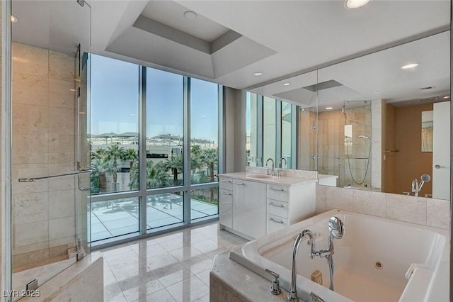 222 Karen Ave Unit 302, Las Vegas, NV 89109 - full bath featuring recessed lighting, a wall of windows, vanity, a stall shower, and a jetted tub