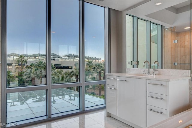 222 Karen Ave Unit 302, Las Vegas, NV 89109 - bathroom with tile patterned flooring, a wall of windows, a wealth of natural light, and vanity
