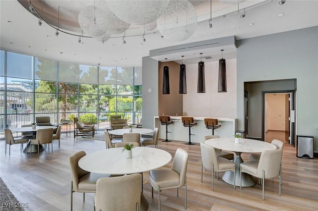 222 Karen Ave Unit 302, Las Vegas, NV 89109 - interior space with a towering ceiling, track lighting, floor to ceiling windows, and light wood-style flooring