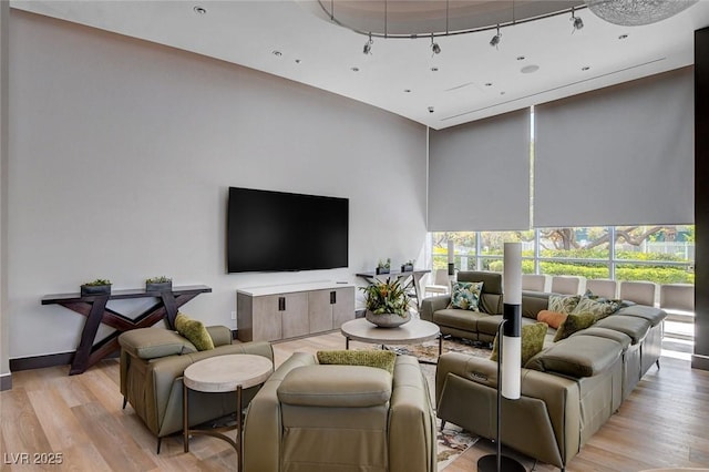 222 Karen Ave Unit 302, Las Vegas, NV 89109 - living room with rail lighting, light wood finished floors, and a towering ceiling