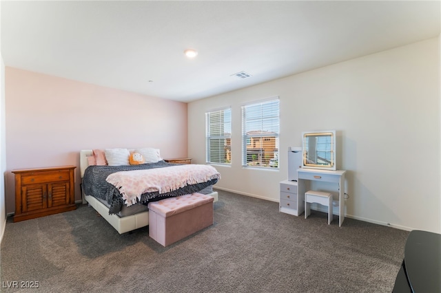 carpeted bedroom featuring visible vents and baseboards