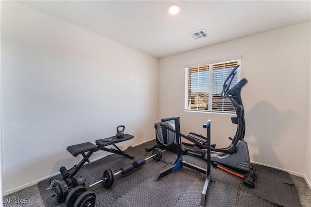 exercise area featuring visible vents, baseboards, and carpet