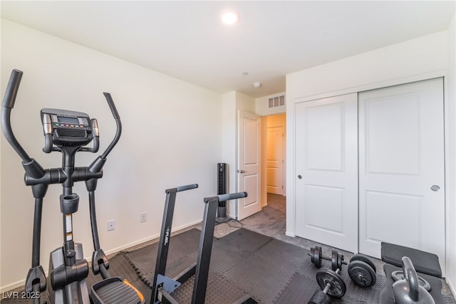 exercise area with visible vents, baseboards, and carpet flooring