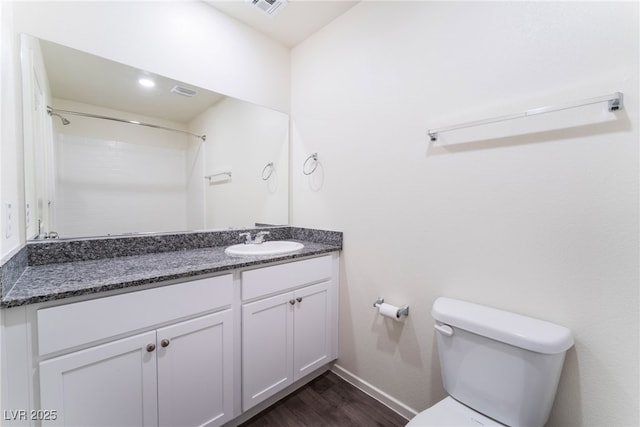 full bathroom featuring vanity, baseboards, toilet, visible vents, and wood finished floors