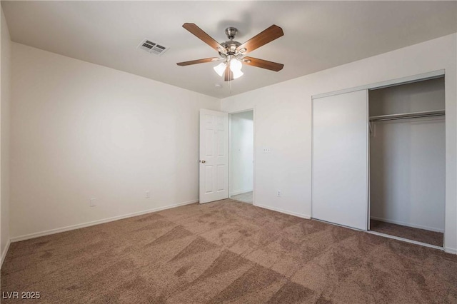 unfurnished bedroom with a closet, baseboards, carpet flooring, a ceiling fan, and visible vents
