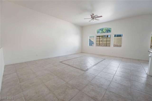 tiled spare room with a ceiling fan