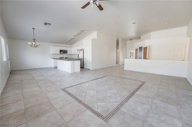 unfurnished living room with visible vents, baseboards, lofted ceiling, and ceiling fan with notable chandelier
