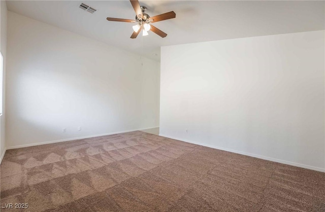 carpeted spare room with visible vents, baseboards, and ceiling fan