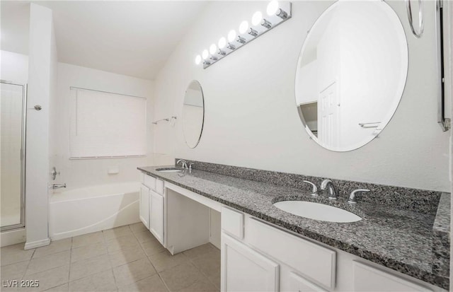 full bathroom with a shower stall, a bath, a sink, and tile patterned flooring