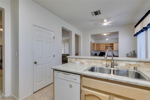 kitchen featuring visible vents, light tile patterned floors, white dishwasher, a sink, and a ceiling fan