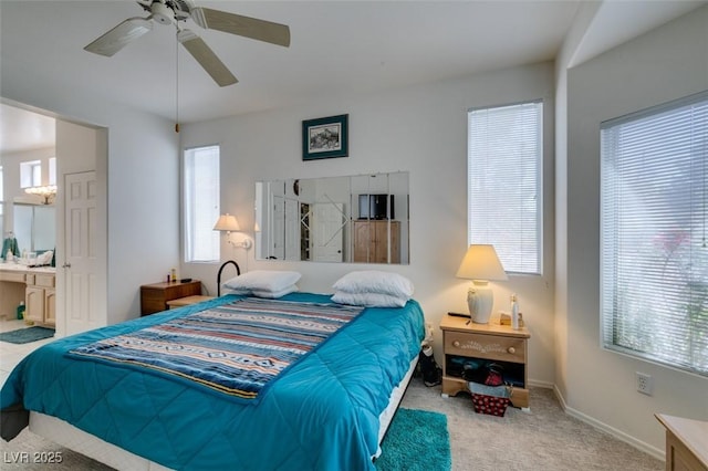 bedroom with carpet flooring, ensuite bathroom, baseboards, and a ceiling fan