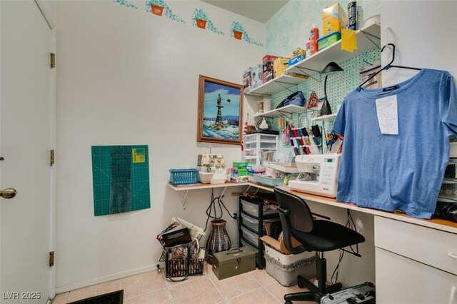 office area featuring tile patterned floors, built in study area, and baseboards