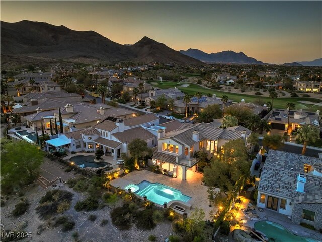 11573 Glowing Sunset Ln, Las Vegas, NV 89135 - aerial view of residential area with a pool area and a mountain backdrop