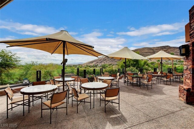 11573 Glowing Sunset Ln, Las Vegas, NV 89135 - view of patio / terrace with a mountain view and outdoor dining area