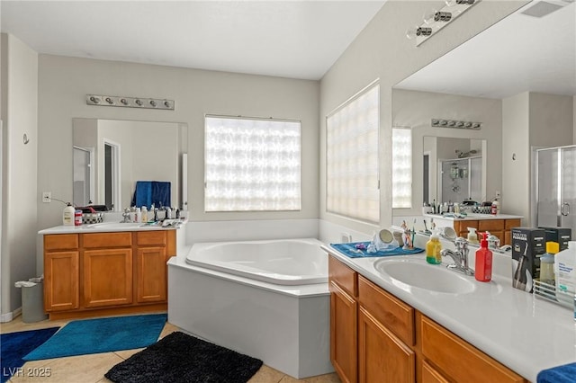 2244 Manosque Ln, Henderson, NV 89044 - bathroom featuring a stall shower, tile patterned floors, a bath, visible vents, and a sink