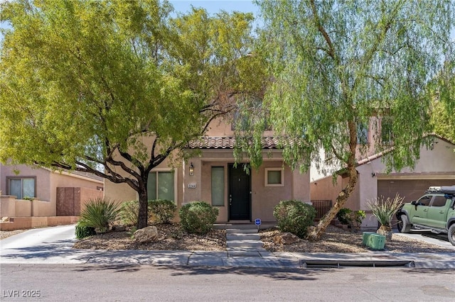 2244 Manosque Ln, Henderson, NV 89044 - view of front of home featuring a garage, stucco siding, and a tile roof