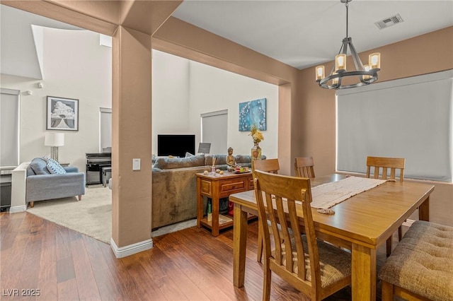 2244 Manosque Ln, Henderson, NV 89044 - dining area featuring visible vents, baseboards, a notable chandelier, and hardwood / wood-style flooring