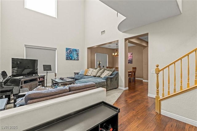 2244 Manosque Ln, Henderson, NV 89044 - living area featuring visible vents, baseboards, a chandelier, wood finished floors, and stairs