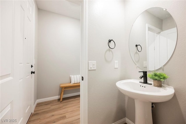 bathroom featuring wood finished floors and baseboards