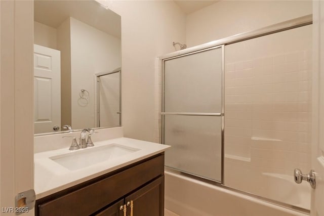 bathroom with shower / bath combination with glass door and vanity