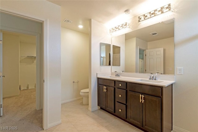 full bath with double vanity, visible vents, a sink, and toilet