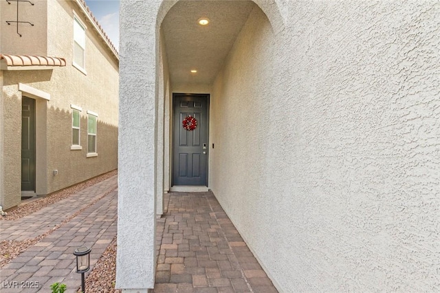 view of exterior entry with stucco siding
