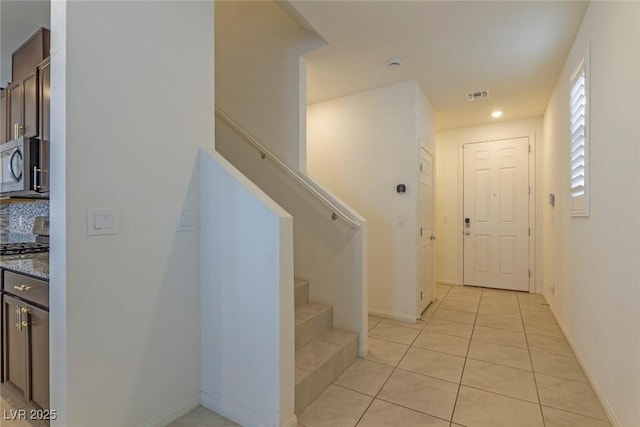 staircase with visible vents, tile patterned floors, recessed lighting, and baseboards