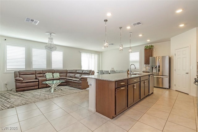kitchen with open floor plan, appliances with stainless steel finishes, visible vents, and a healthy amount of sunlight