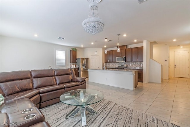 living room with a chandelier, light tile patterned floors, visible vents, and recessed lighting