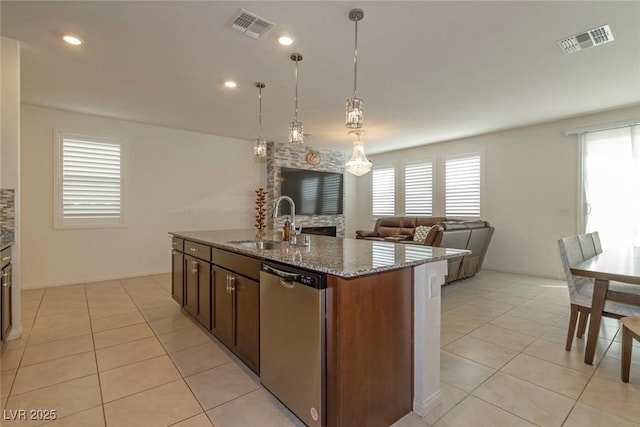 kitchen with light tile patterned floors, dishwasher, a sink, and visible vents