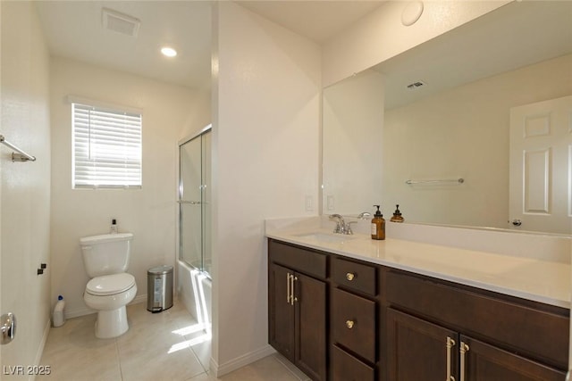 bathroom featuring visible vents, baseboards, toilet, vanity, and shower / bath combination with glass door