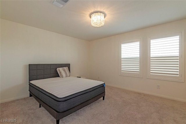 carpeted bedroom with visible vents and baseboards