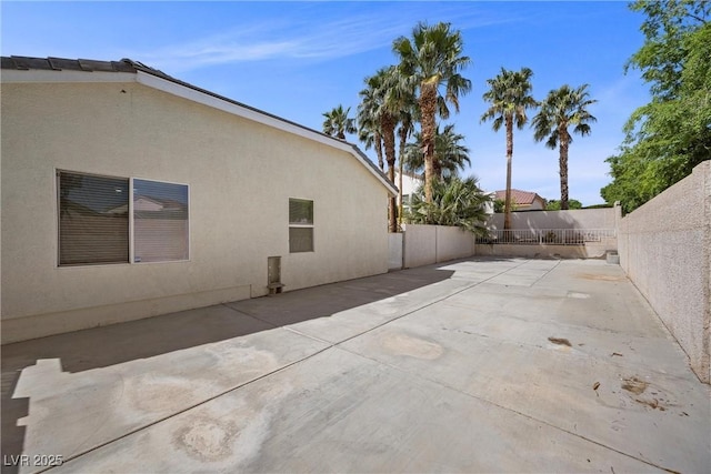 7460 Grassy Field Ct, Las Vegas, NV 89131 - view of side of property featuring a fenced backyard, stucco siding, and a patio