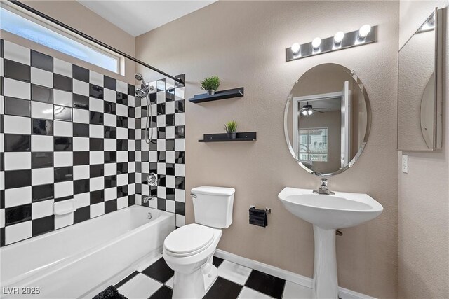 7460 Grassy Field Ct, Las Vegas, NV 89131 - bathroom with ceiling fan, toilet, bathtub / shower combination, and baseboards