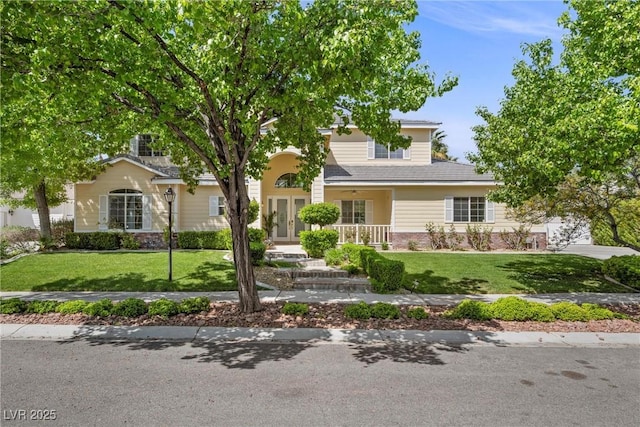 7460 Grassy Field Ct, Las Vegas, NV 89131 - obstructed view of property featuring french doors, a front lawn, and covered porch