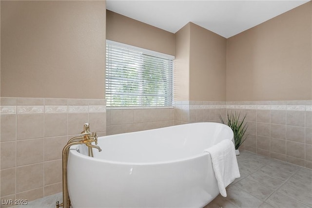 7460 Grassy Field Ct, Las Vegas, NV 89131 - full bathroom featuring a freestanding tub, tile walls, and wainscoting