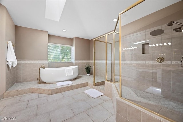 7460 Grassy Field Ct, Las Vegas, NV 89131 - bathroom featuring a freestanding bath, a tile shower, tile walls, tile patterned flooring, and a skylight
