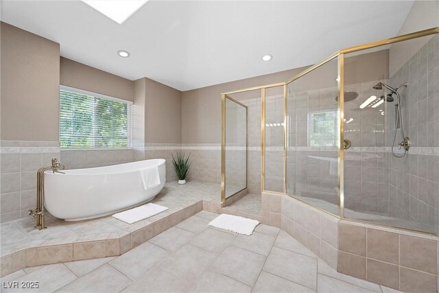 7460 Grassy Field Ct, Las Vegas, NV 89131 - full bathroom with a freestanding bath, a stall shower, tile patterned flooring, tile walls, and recessed lighting