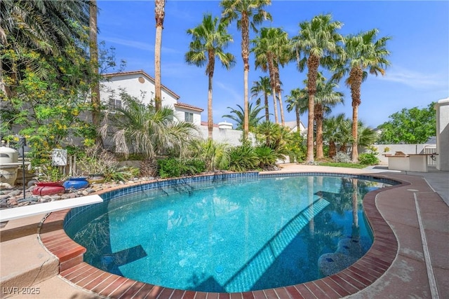 7460 Grassy Field Ct, Las Vegas, NV 89131 - swimming pool featuring a diving board and a patio area