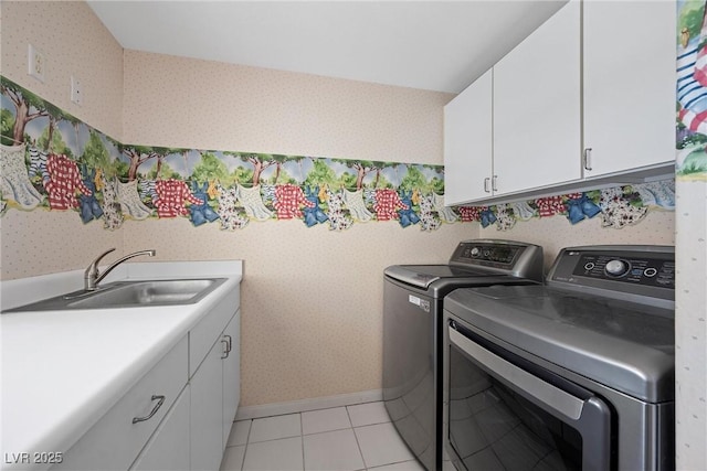 7460 Grassy Field Ct, Las Vegas, NV 89131 - laundry area featuring independent washer and dryer, wallpapered walls, cabinet space, light tile patterned flooring, and baseboards