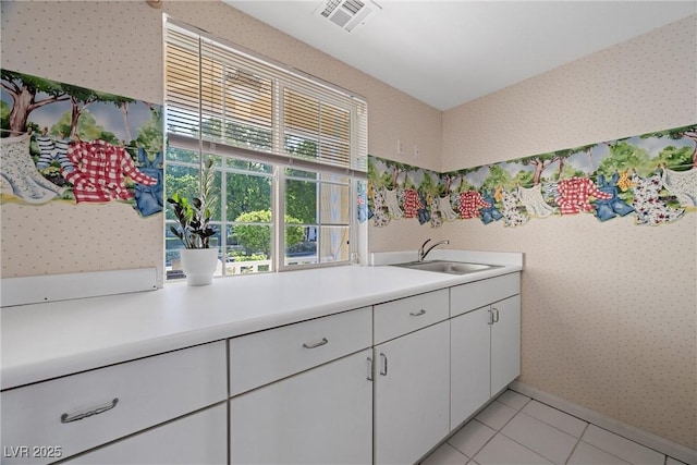 7460 Grassy Field Ct, Las Vegas, NV 89131 - kitchen featuring a sink, wallpapered walls, light countertops, white cabinets, and light tile patterned floors