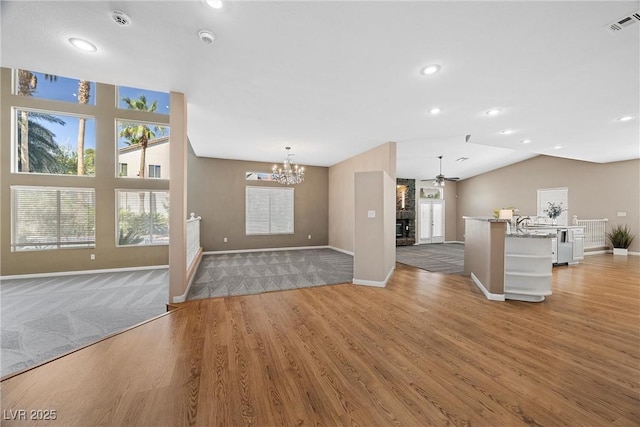 7460 Grassy Field Ct, Las Vegas, NV 89131 - unfurnished living room with a ceiling fan, a chandelier, baseboards, light wood-style flooring, and recessed lighting
