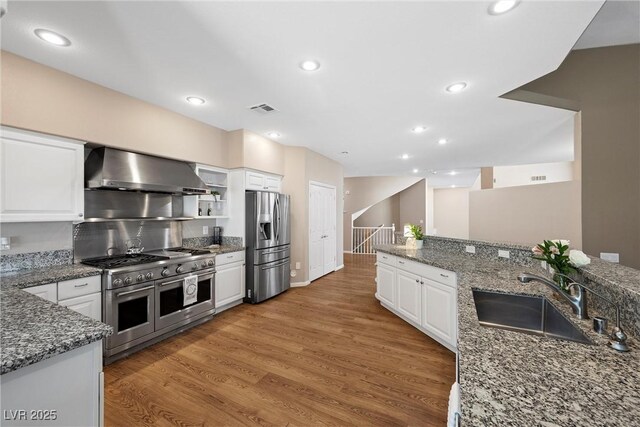 7460 Grassy Field Ct, Las Vegas, NV 89131 - kitchen featuring ventilation hood, stainless steel appliances, a sink, white cabinets, and stone countertops
