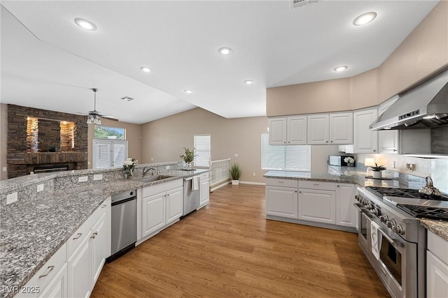 7460 Grassy Field Ct, Las Vegas, NV 89131 - kitchen featuring appliances with stainless steel finishes, ceiling fan, light wood-style flooring, white cabinets, and recessed lighting