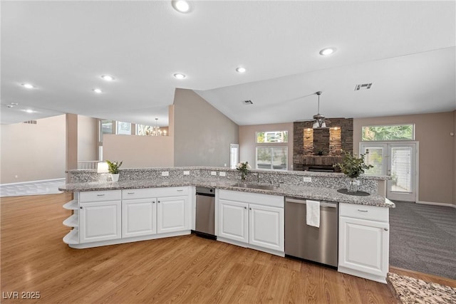 7460 Grassy Field Ct, Las Vegas, NV 89131 - kitchen featuring dishwasher, a sink, open floor plan, light wood-style flooring, and healthy amount of natural light